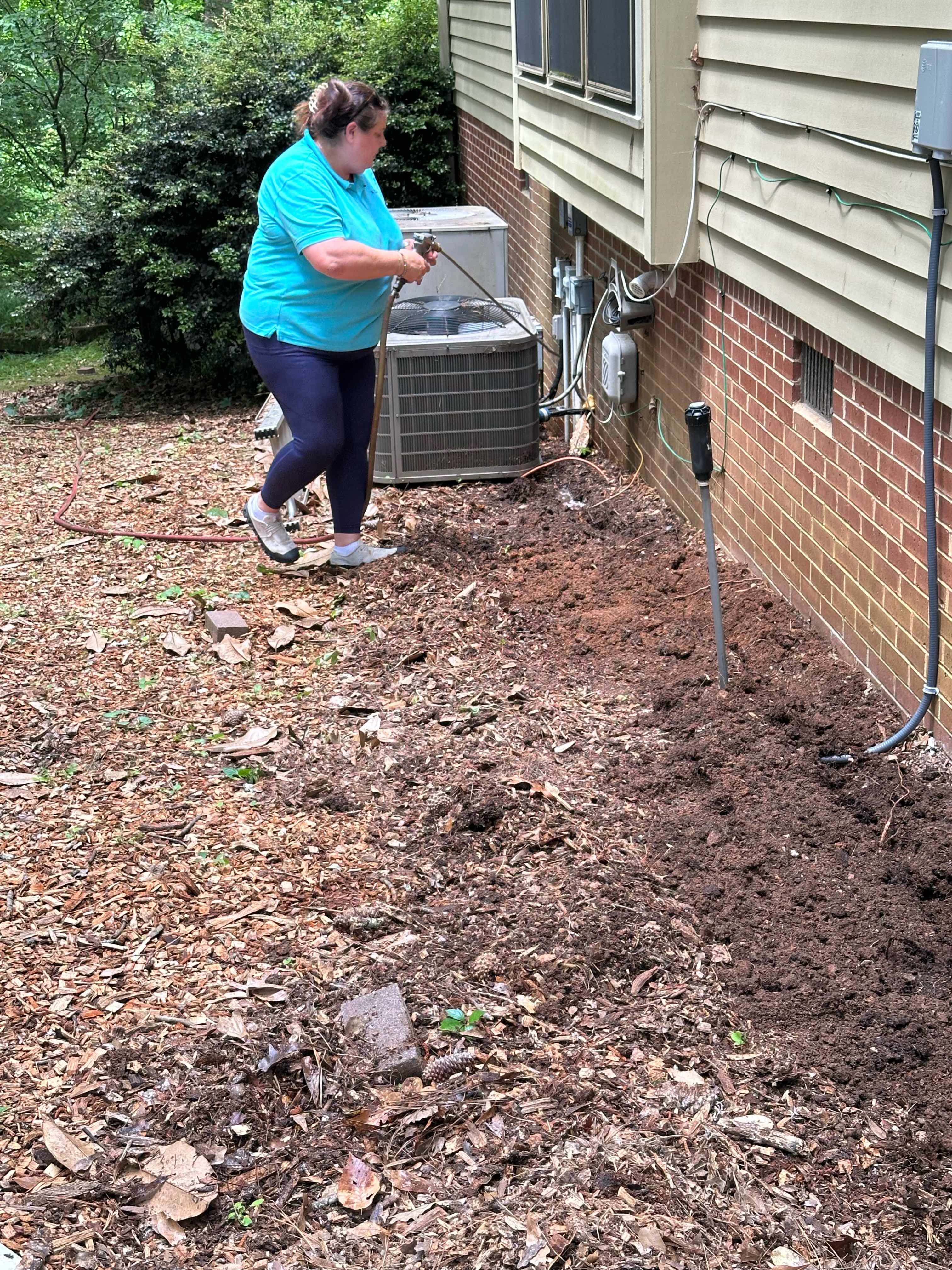 Professional pest control treatment around HVAC unit